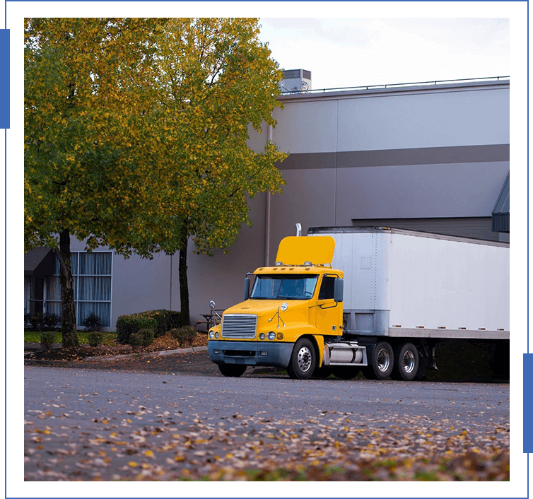 A yellow truck parked in front of a building.